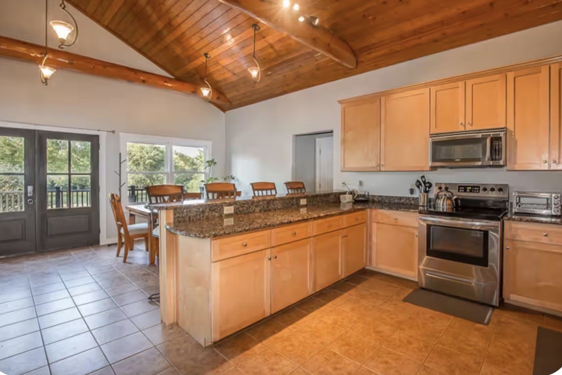 1437 Dividing Ridge Road Goodlettsville, TN 37072 - Photo 7 of 36 a kitchen with stainless steel appliances granite countertop a stove a sink and a microwave