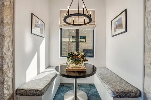 a view of a hallway with furniture and a window