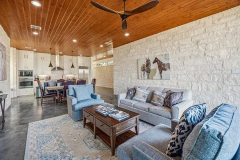 a living room with furniture and kitchen view