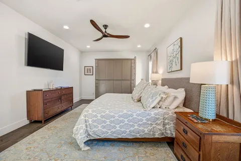 a bedroom with a bed and a flat screen television