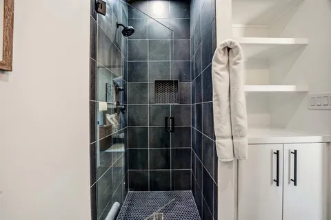 a bathroom with a glass shower door