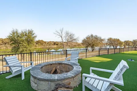 a view of a patio with a table chairs and a backyard