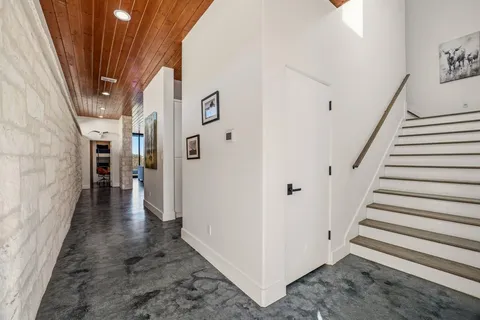 a view of a hallway with wooden floor and entryway
