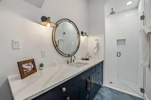 a bathroom with a double vanity sink and a mirror