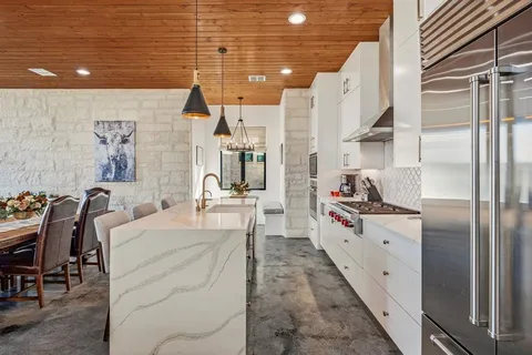 a large white kitchen with lots of counter top space