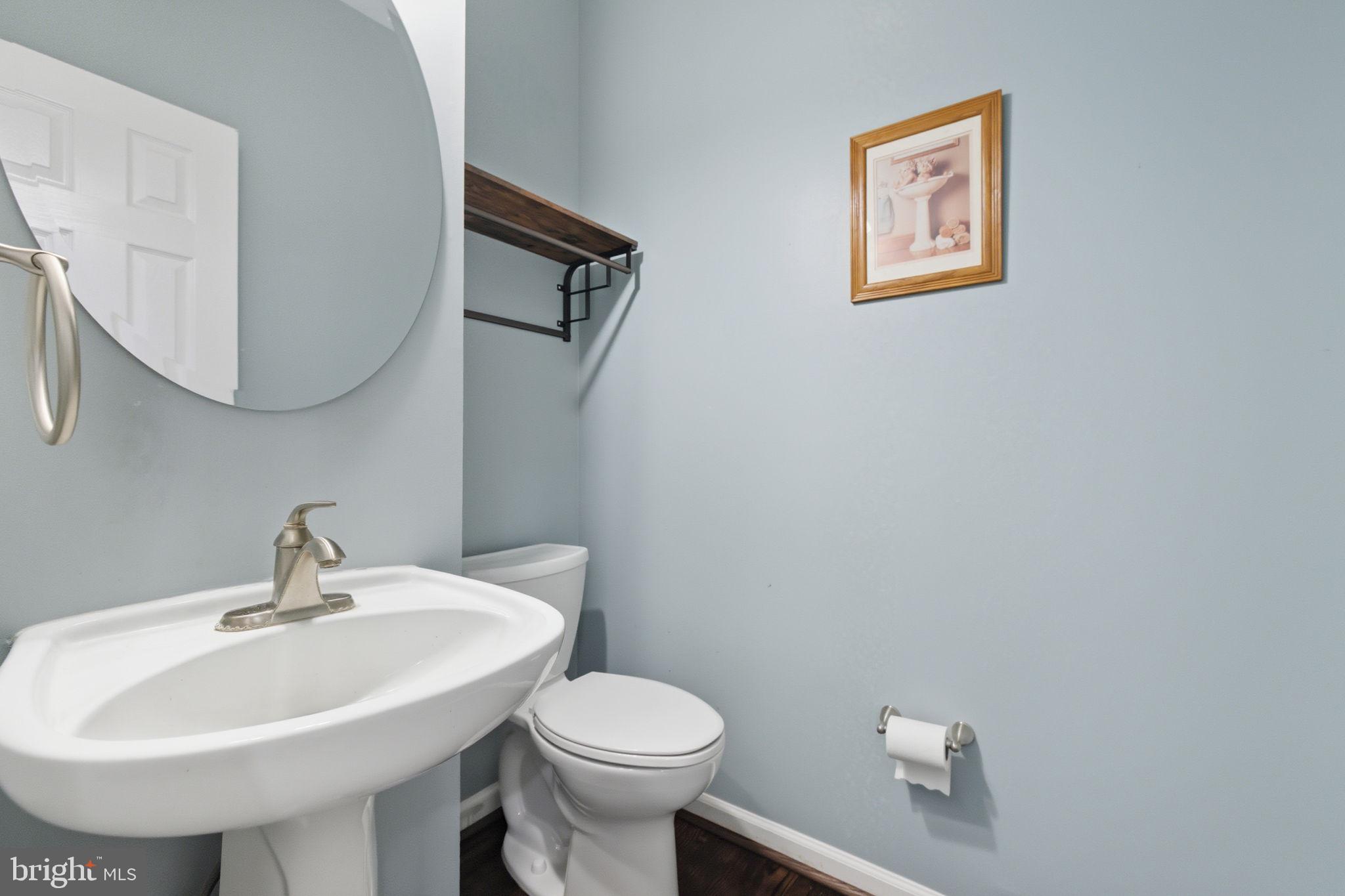 6363 Yates Ford Road Manassas, VA 20111 - Photo 14 of 67 a bathroom with a toilet sink and mirror