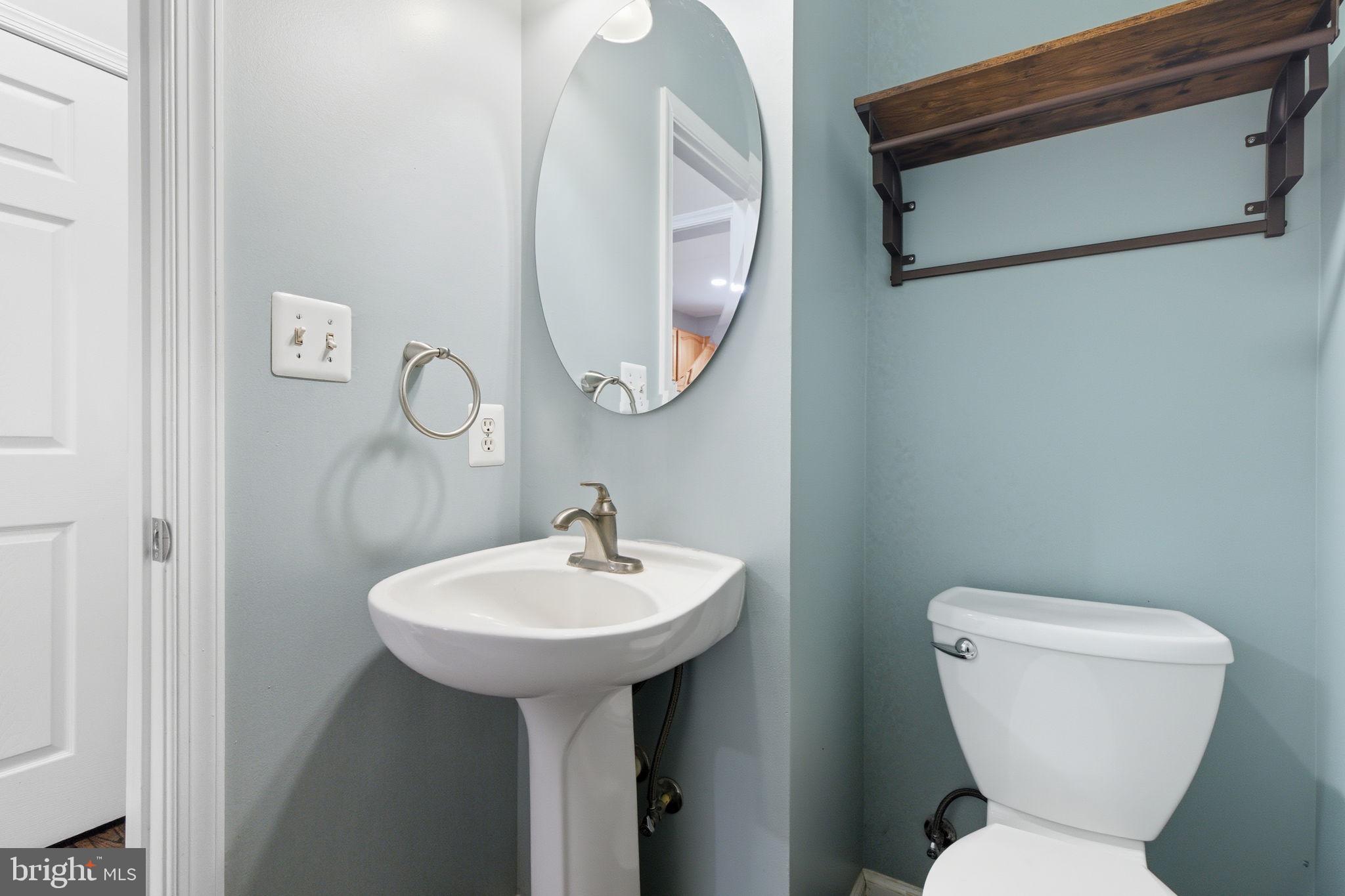 6363 Yates Ford Road Manassas, VA 20111 - Photo 15 of 67 a bathroom with a toilet sink and mirror