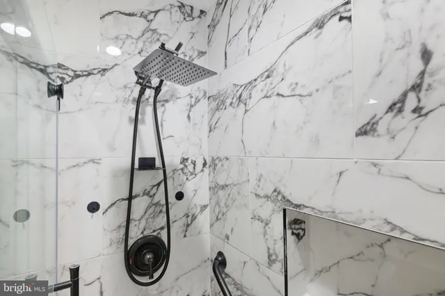 a kitchen with stainless steel appliances granite countertop a refrigerator a sink a stove and a refrigerator with wooden floor