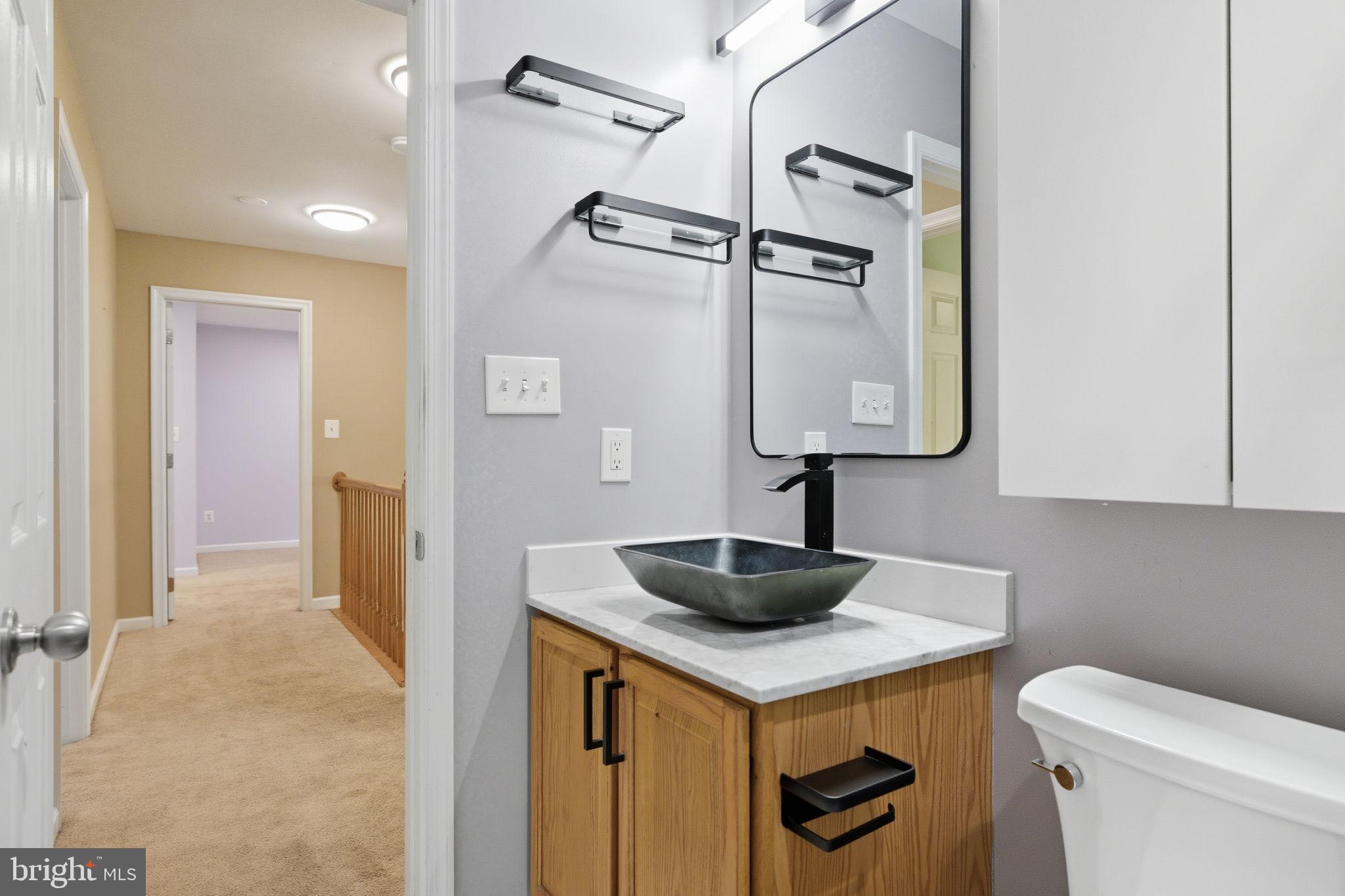 6363 Yates Ford Road Manassas, VA 20111 - Photo 35 of 67 a bathroom with a sink a toilet and vanity