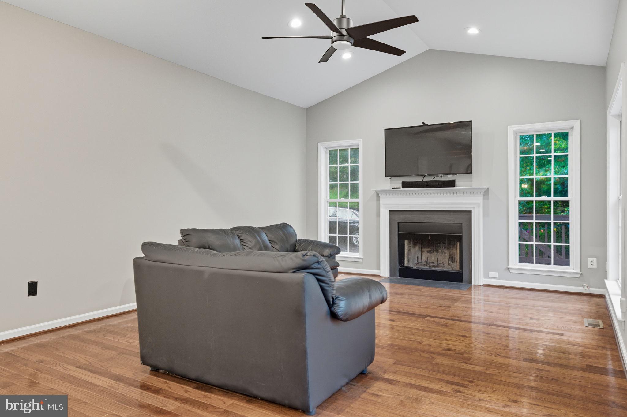 6363 Yates Ford Road Manassas, VA 20111 - Photo 42 of 67 a living room with furniture a flat screen tv and a fireplace