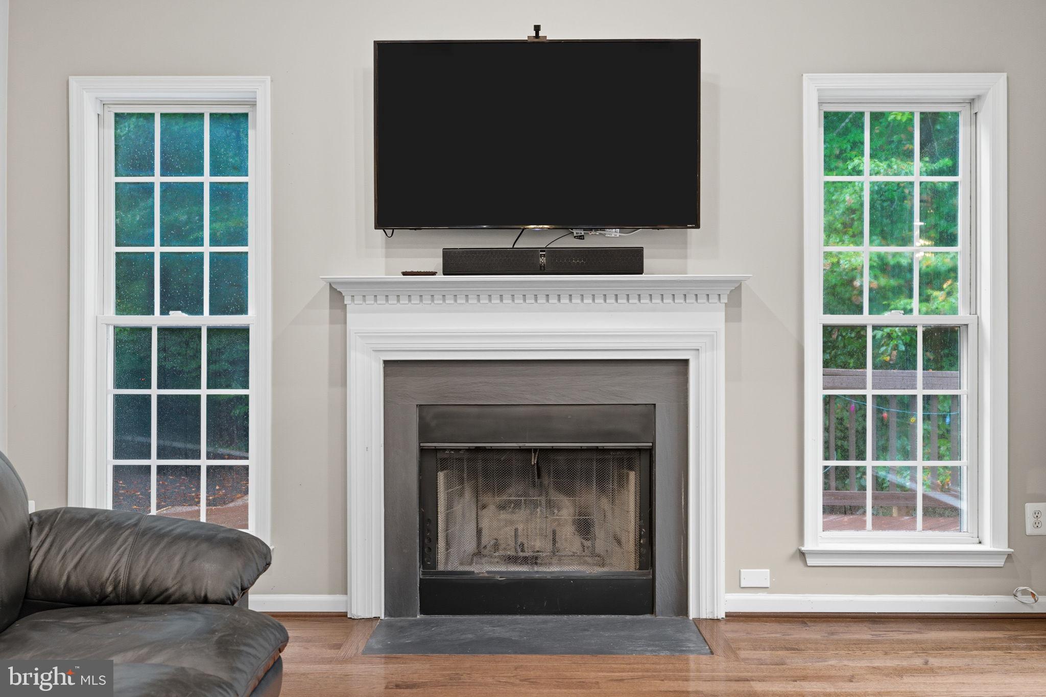 6363 Yates Ford Road Manassas, VA 20111 - Photo 43 of 67 a living room with a fireplace and a flat screen tv