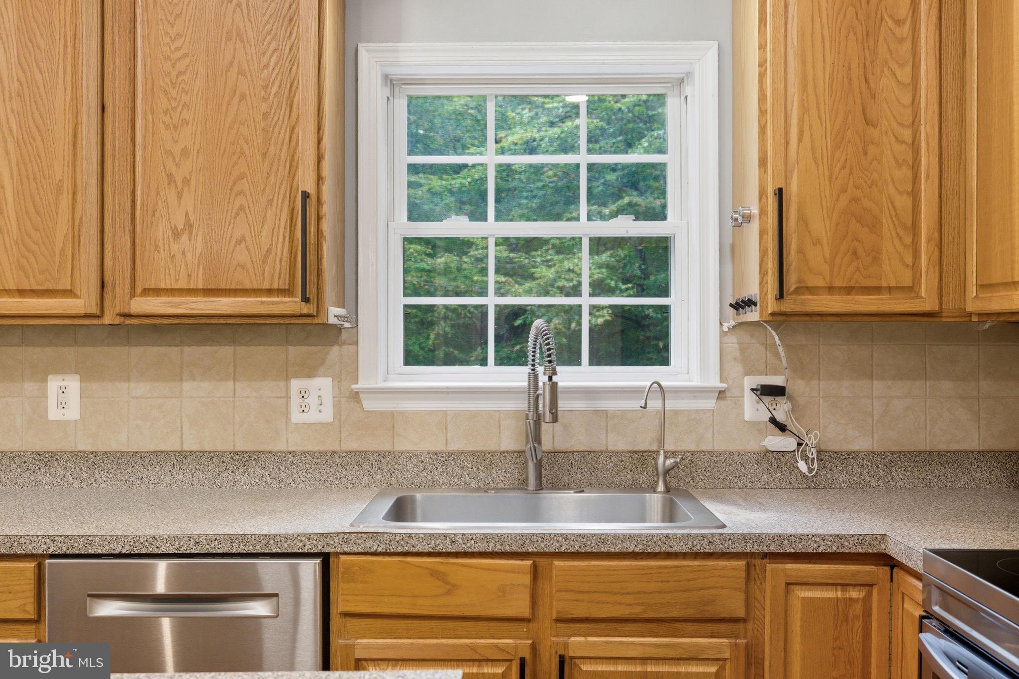 6363 Yates Ford Road Manassas, VA 20111 - Photo 45 of 67 a kitchen with granite countertop stainless steel appliances window sink and cabinets