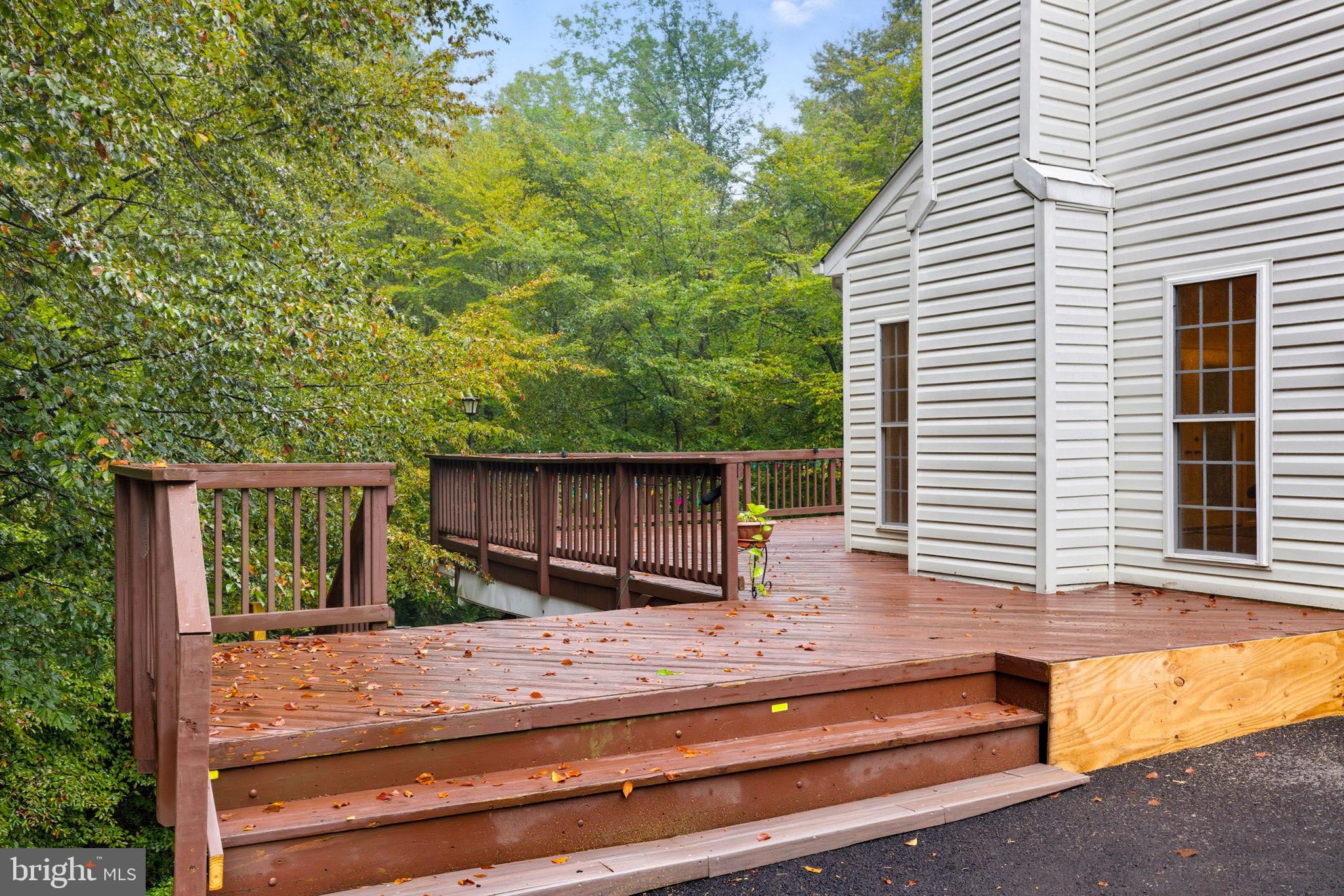 6363 Yates Ford Road Manassas, VA 20111 - Photo 54 of 67 a backyard of a house with large tree and wooden fence