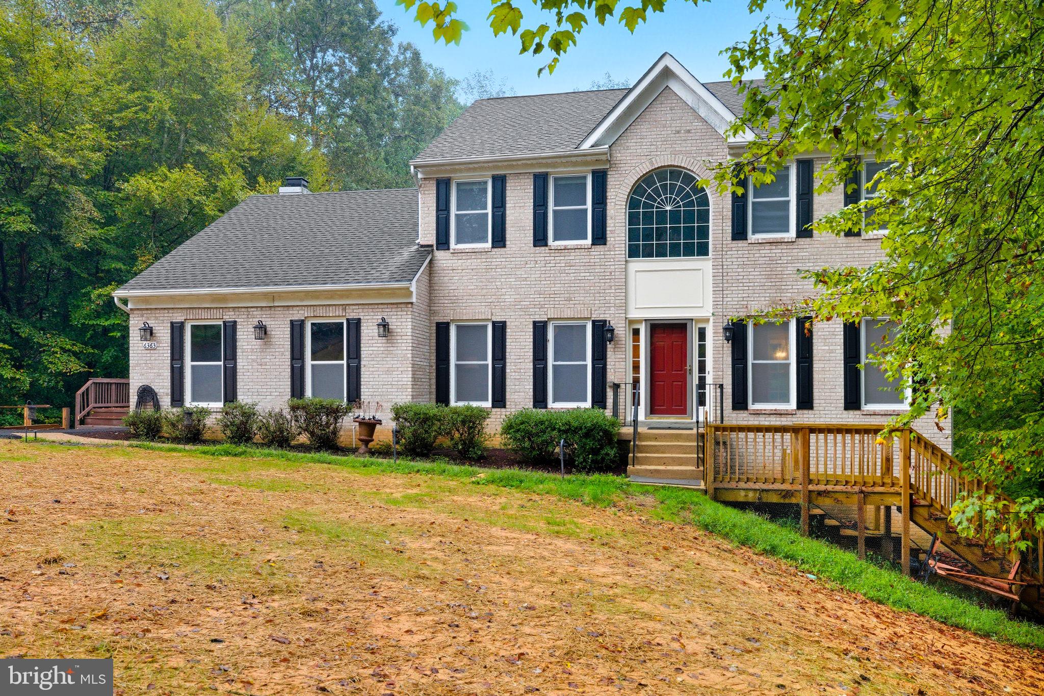 6363 Yates Ford Road Manassas, VA 20111 - Photo 67 of 67 a front view of a house with a yard and potted plants