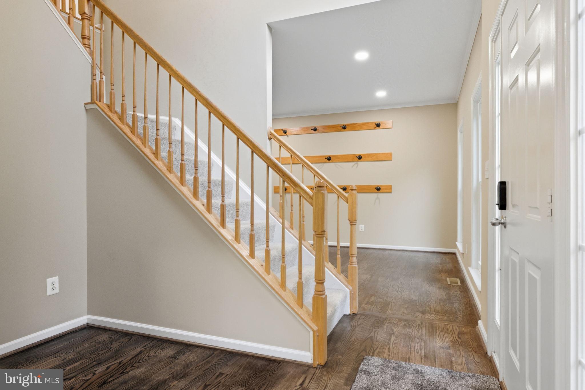 6363 Yates Ford Road Manassas, VA 20111 - Photo 9 of 67 a view of a hallway with wooden floor and staircase
