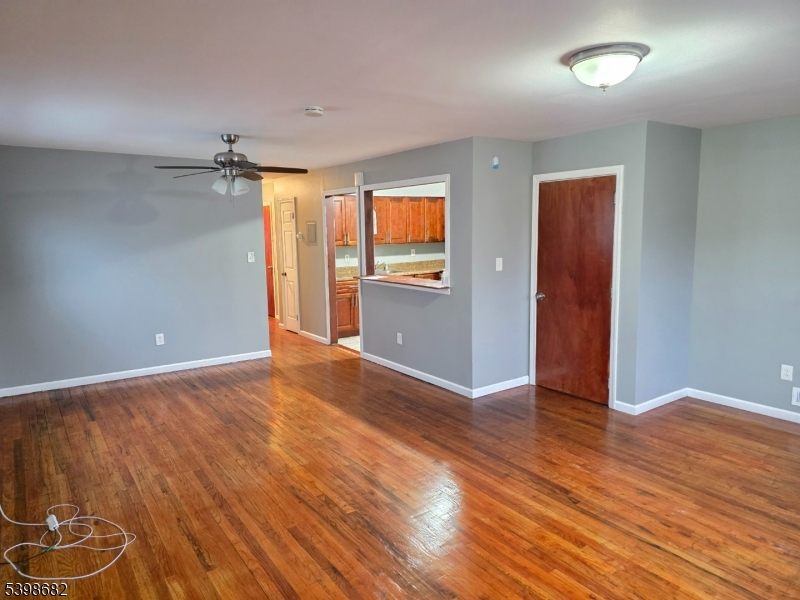 97 Goodwin Avenue Newark, NJ 07112 - Photo 11 of 20 an empty room with wooden floor and windows