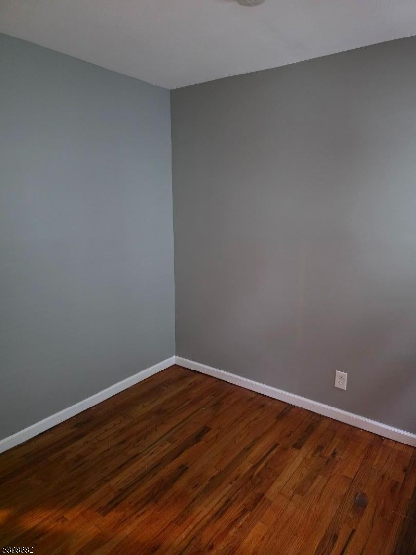 97 Goodwin Avenue Newark, NJ 07112 - Photo 14 of 20 a view of an empty room with wooden floor