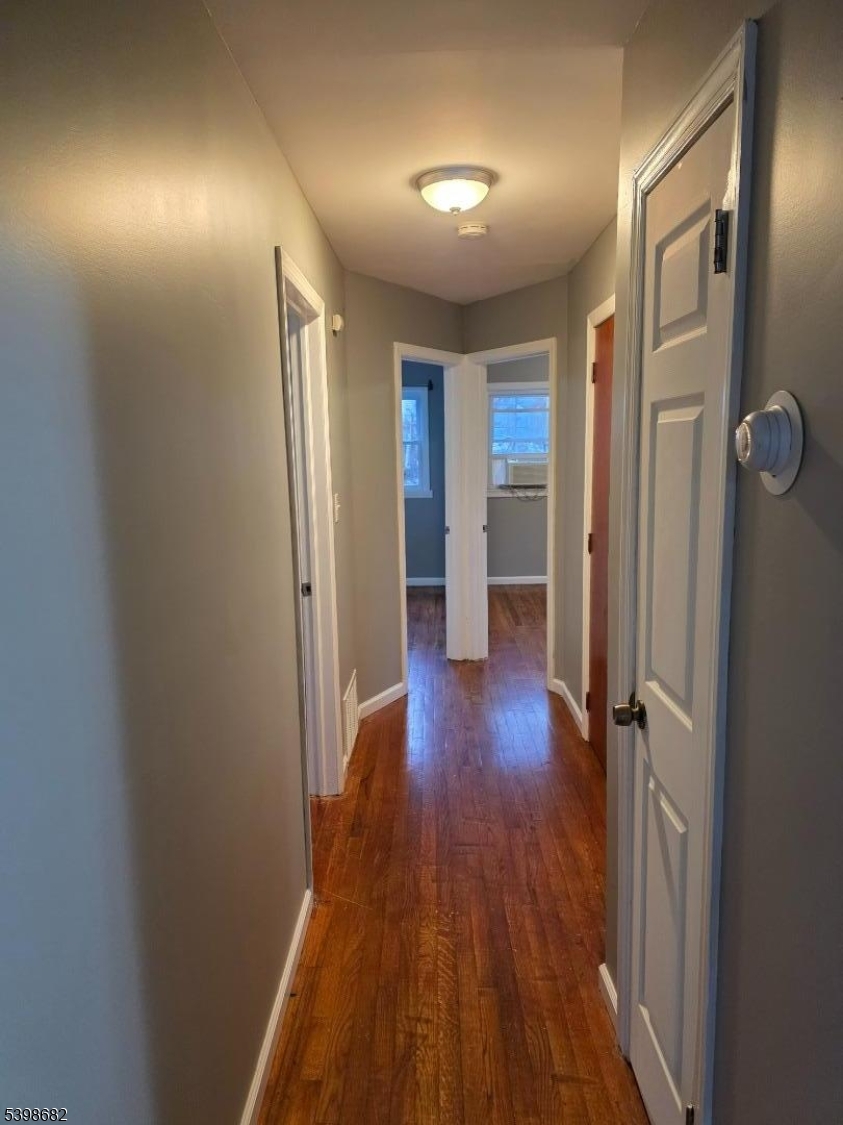 97 Goodwin Avenue Newark, NJ 07112 - Photo 20 of 20 wooden floor in an empty room with a window