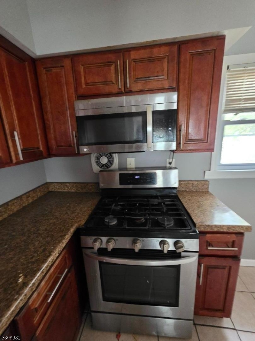 97 Goodwin Avenue Newark, NJ 07112 - Photo 8 of 20 a kitchen with granite countertop a stove and a microwave