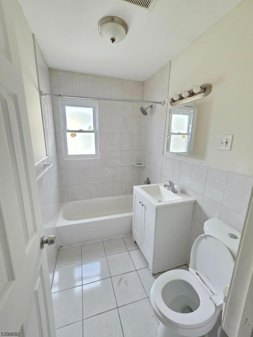 97 Goodwin Avenue Newark, NJ 07112 - Photo 9 of 20 a bath room with a toilet a bath tub and a shower