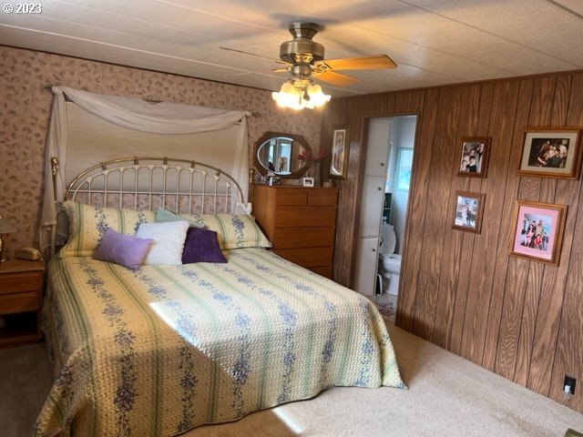 3998 Franklin Boulevard Eugene, OR 97403 - Photo 23 of 35 a bedroom with a large bed and a chandelier