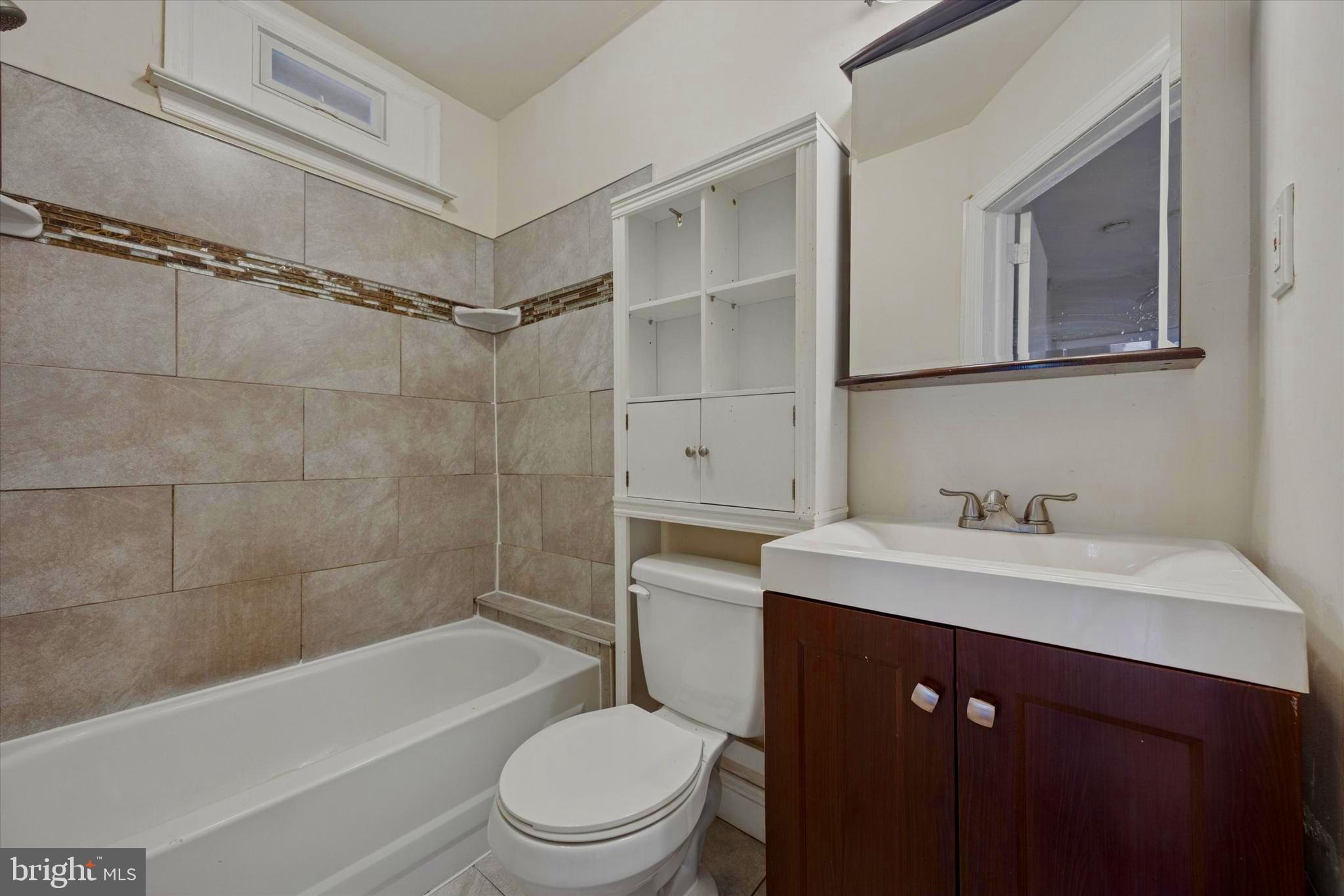 1549 North Wanamaker Street Philadelphia, PA 19131 - Photo 11 of 15 a bathroom with a sink a toilet and shower