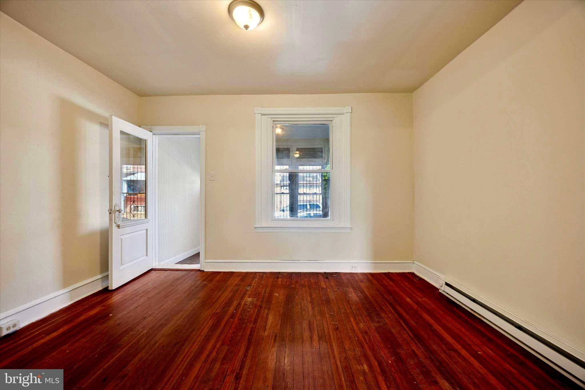1549 North Wanamaker Street Philadelphia, PA 19131 - Photo 4 of 15 an empty room with wooden floor and windows