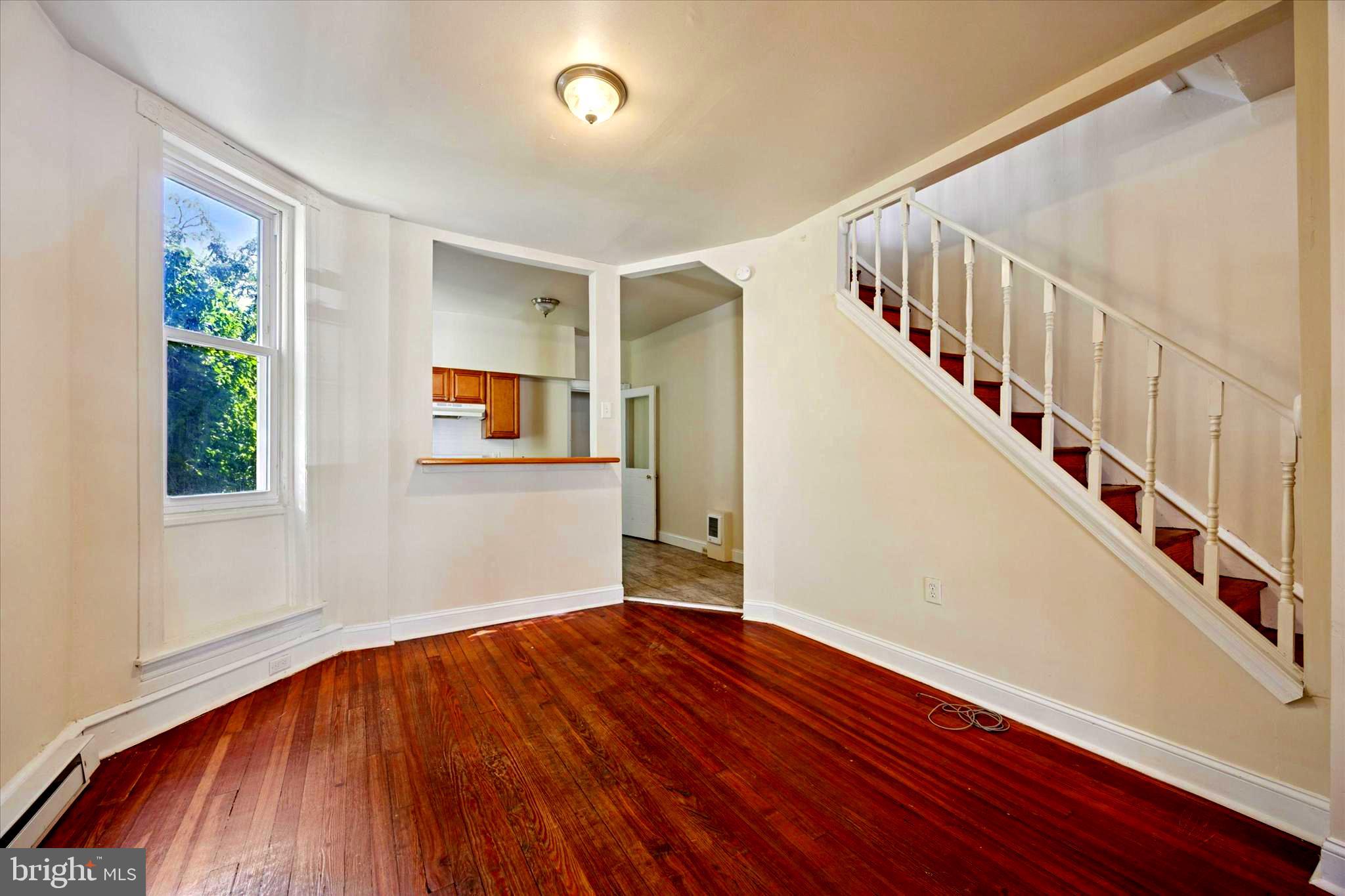 1549 North Wanamaker Street Philadelphia, PA 19131 - Photo 5 of 15 a view of an empty room with wooden floor and stairs