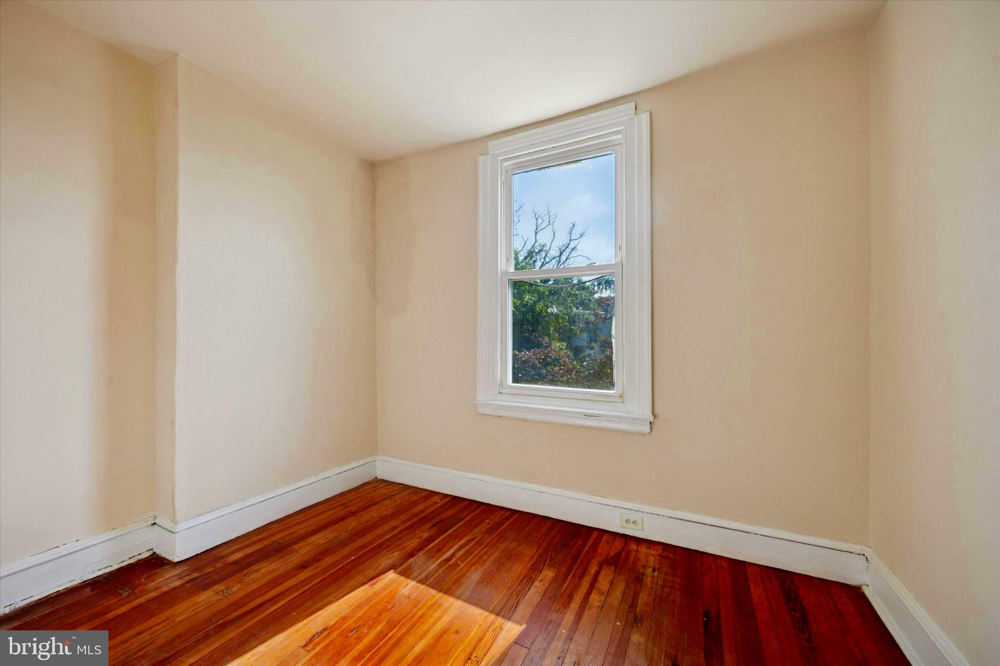 1549 North Wanamaker Street Philadelphia, PA 19131 - Photo 10 of 15 a view of an empty room with wooden floor and a window