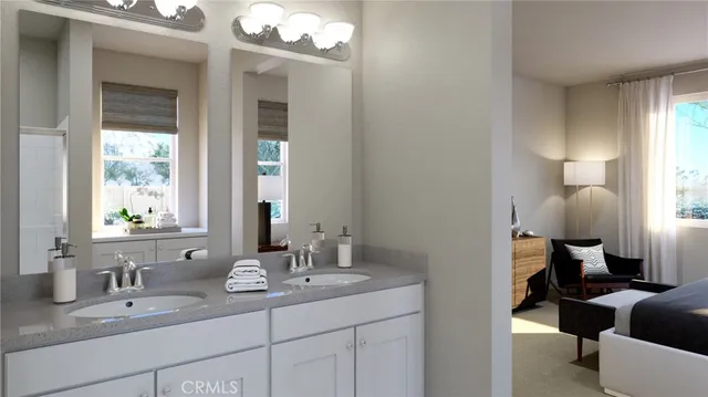 a en suite bathroom with a double vanity sink and a mirror