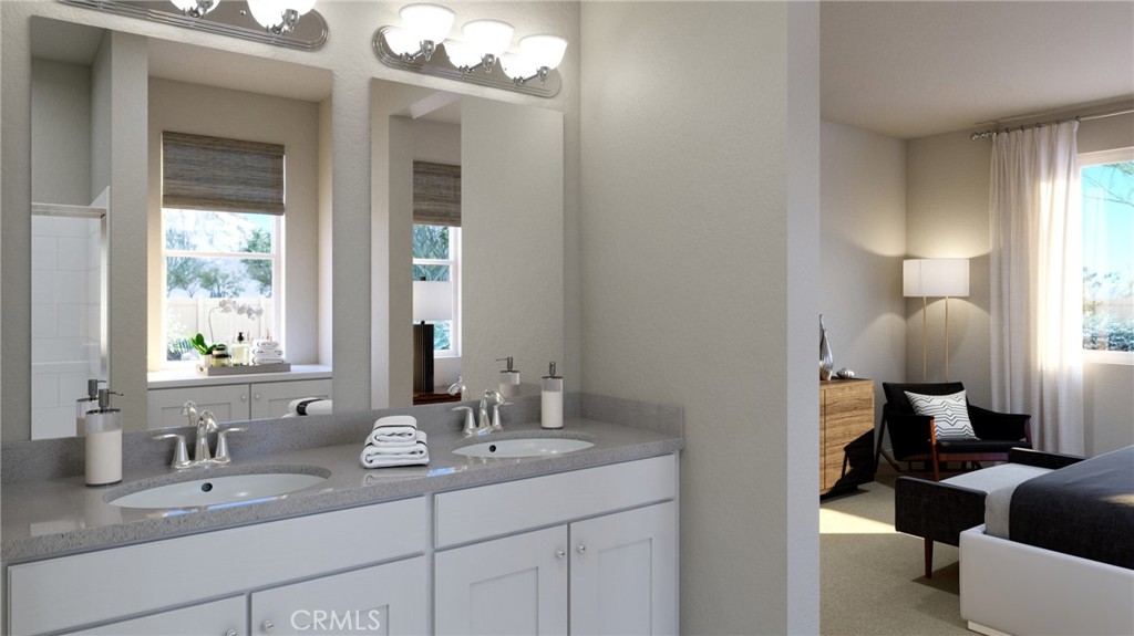 4072 Daisy Lane Banning, CA 92220 - Photo 14 of 15 a en suite bathroom with a double vanity sink and a mirror