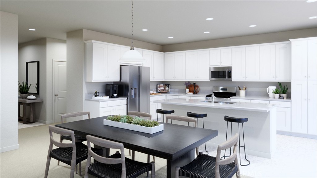 4072 Daisy Lane Banning, CA 92220 - Photo 7 of 15 a kitchen with a dining table chairs refrigerator and microwave