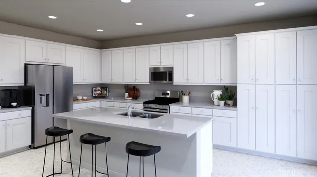 a kitchen with stainless steel appliances a refrigerator sink and white cabinets