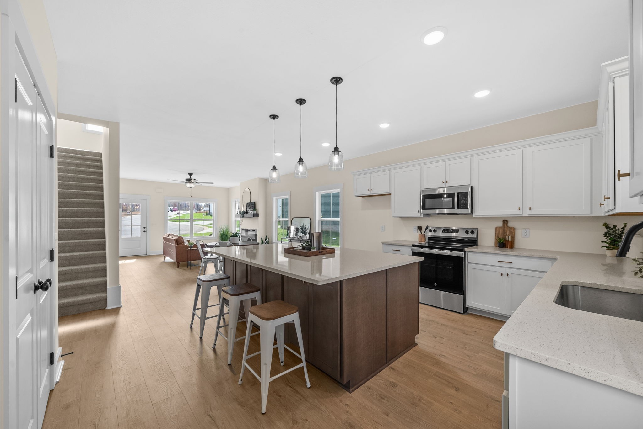 194 Dewberry Road Clarksville, TN 37042 - Photo 17 of 62 a kitchen with stainless steel appliances kitchen island granite countertop a stove top oven a sink a dining table and chairs with wooden floor