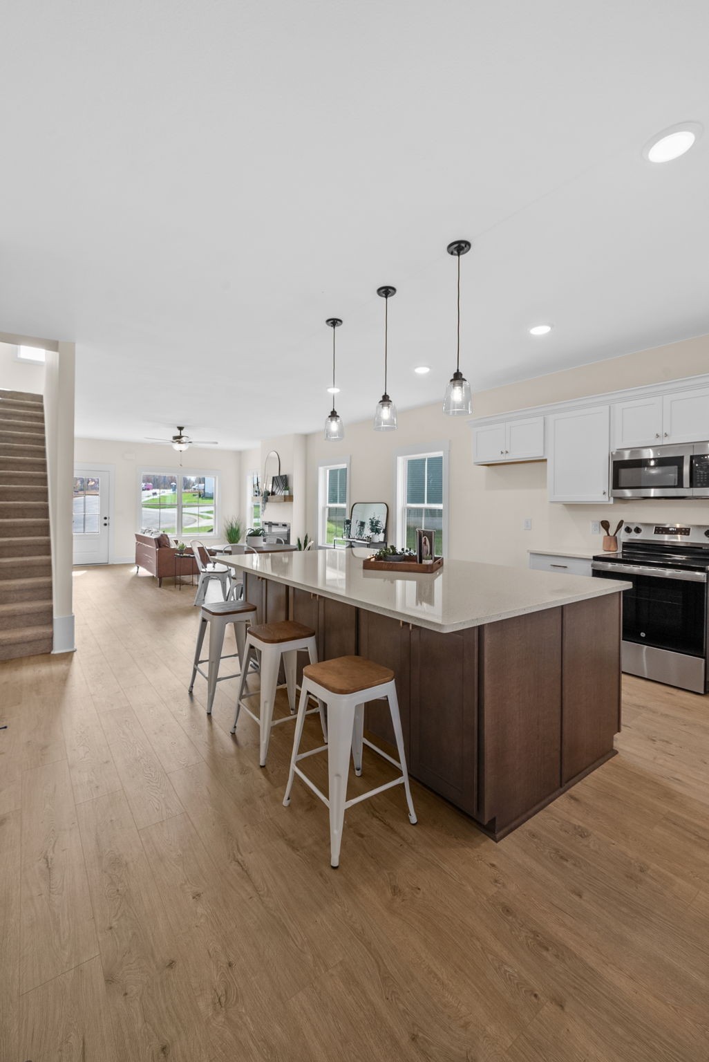 194 Dewberry Road Clarksville, TN 37042 - Photo 48 of 62 a kitchen with stainless steel appliances kitchen island granite countertop a table chairs sink and cabinets