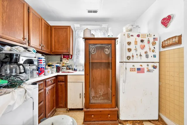 a kitchen with refrigerator and cabinets