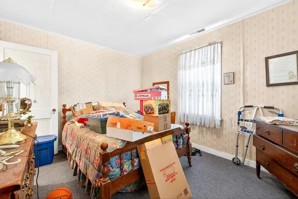 a bedroom with furniture and a window