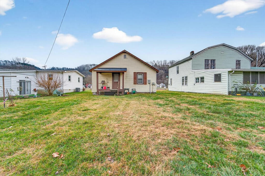 413 Commerce Avenue Iron Gate, VA 24422 - Photo 18 of 18 a view of a house with a big yard and large trees