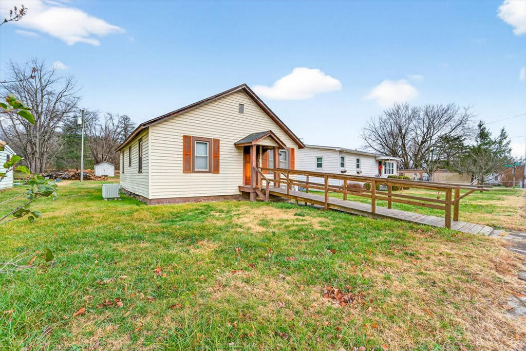 413 Commerce Avenue Iron Gate, VA 24422 - Photo 2 of 18 a view of a house with a yard and sitting area