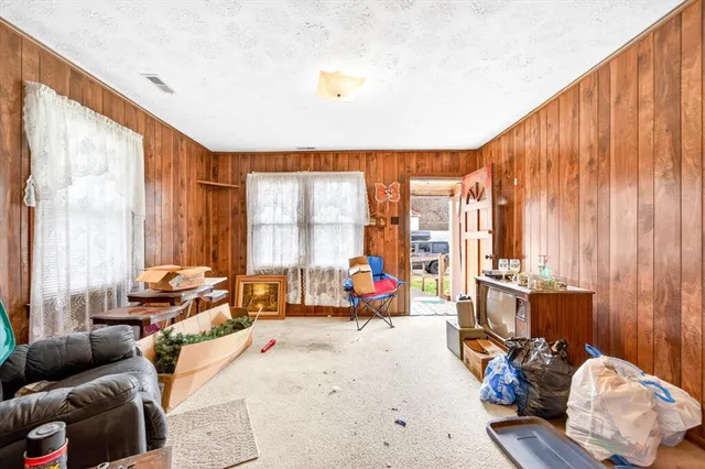 a living room with furniture and floor to ceiling windows