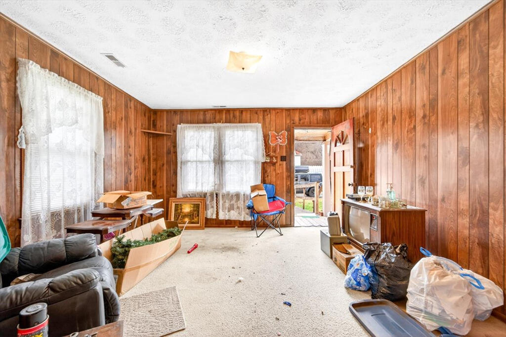 413 Commerce Avenue Iron Gate, VA 24422 - Photo 5 of 18 a living room with furniture and floor to ceiling windows