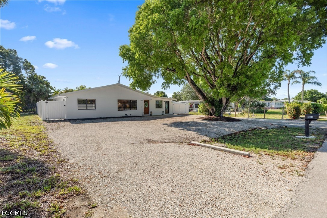 1200 Patterson Road Cape Coral, FL 33909 - Photo 33 of 42 a house with trees in front of it