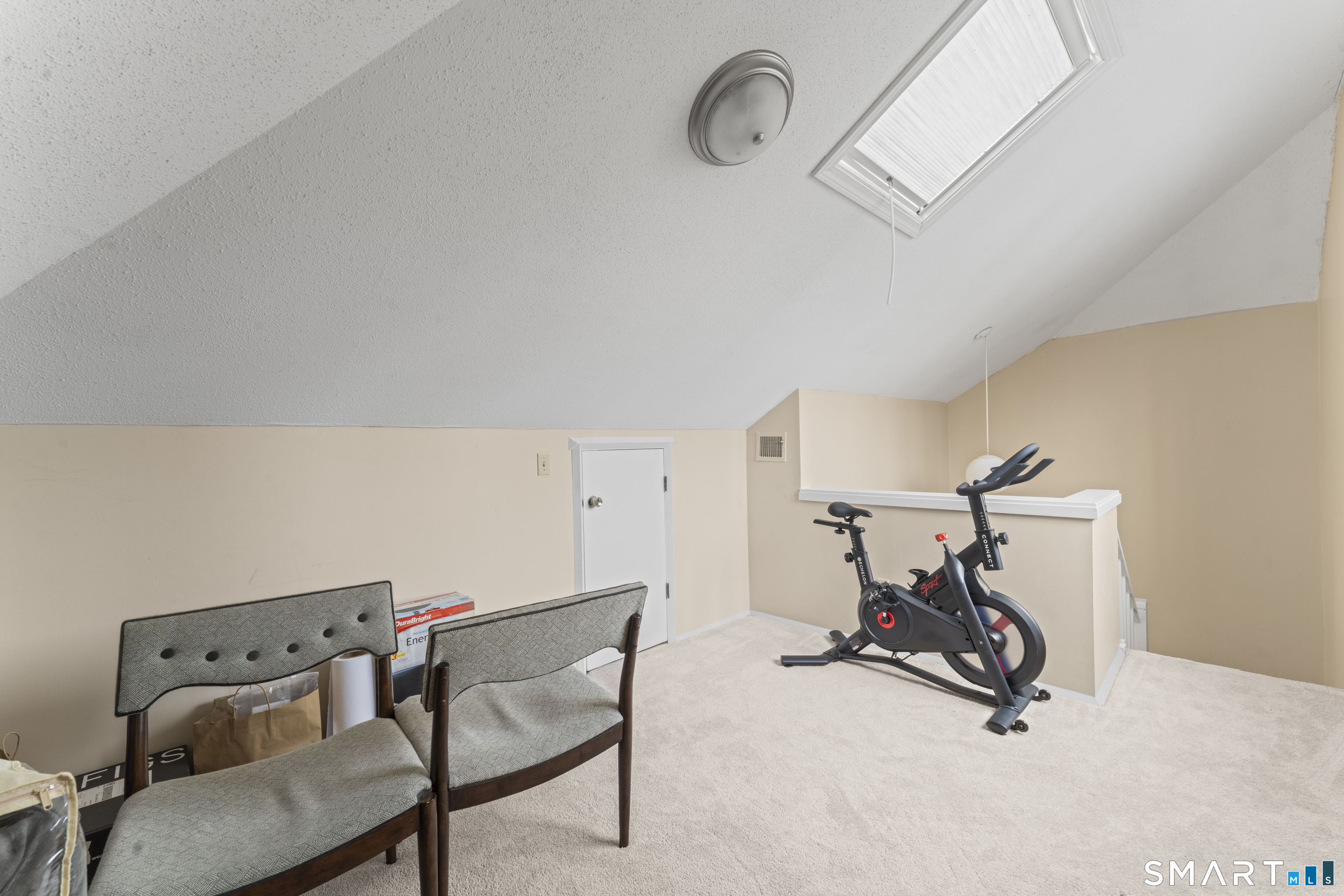 5 Talcott Ridge Road, Unit F Farmington, CT 06032 - Photo 26 of 31 Loft / Bonus Area - Alternate view of the upper-level loft highlighting natural light and carpeted flooring.