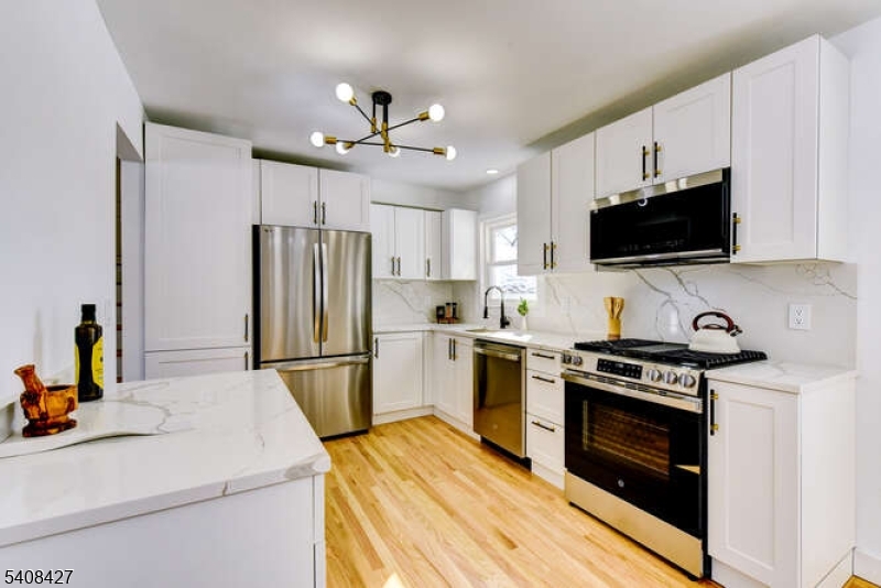 22 Glen Road Bridgewater, NJ 08805 - Photo 24 of 48 a kitchen with a stove a refrigerator and a microwave