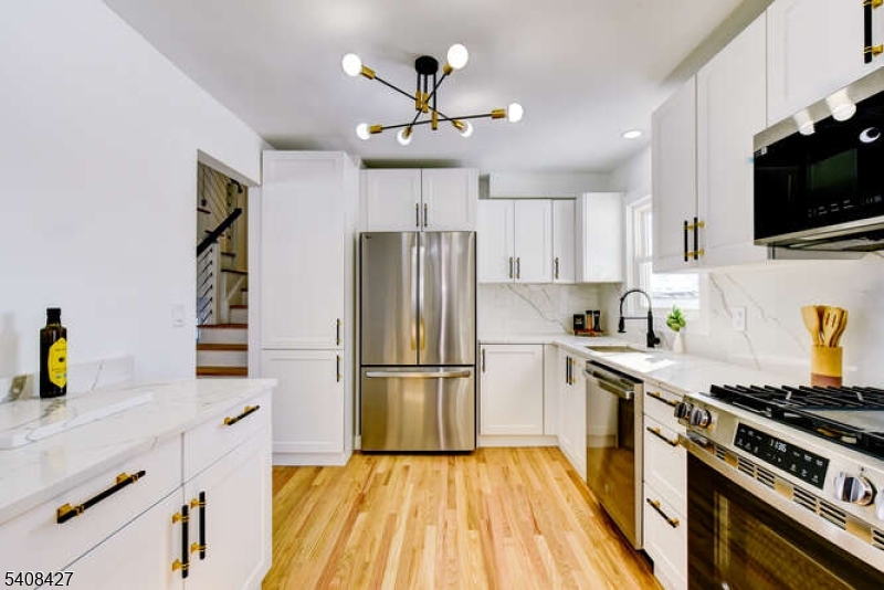 22 Glen Road Bridgewater, NJ 08805 - Photo 25 of 48 a kitchen with a refrigerator and a stove top oven
