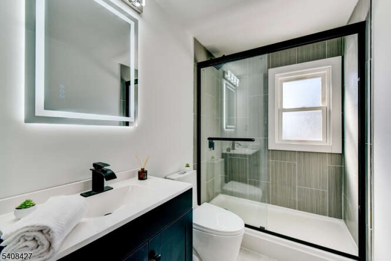 22 Glen Road Bridgewater, NJ 08805 - Photo 33 of 48 a bathroom with a sink a toilet and shower