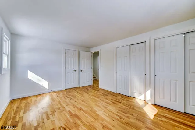a view of an empty room and wooden floor