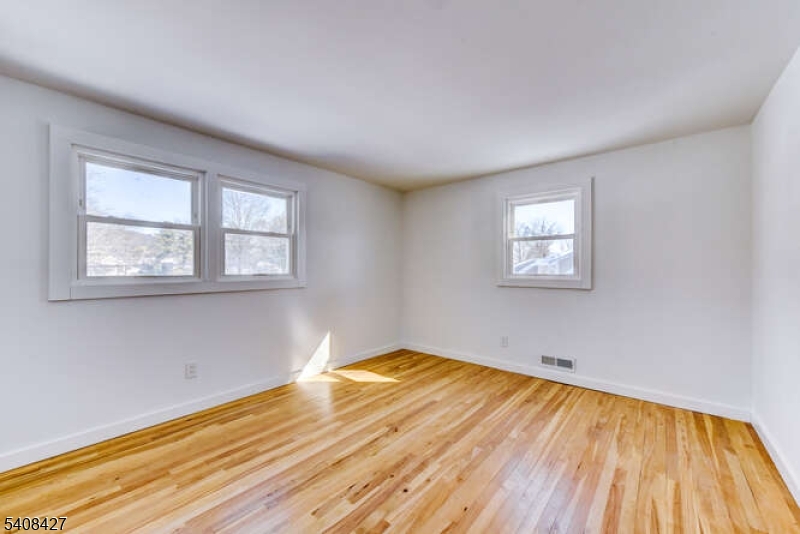 22 Glen Road Bridgewater, NJ 08805 - Photo 36 of 48 a view of empty room with wooden floor and fan