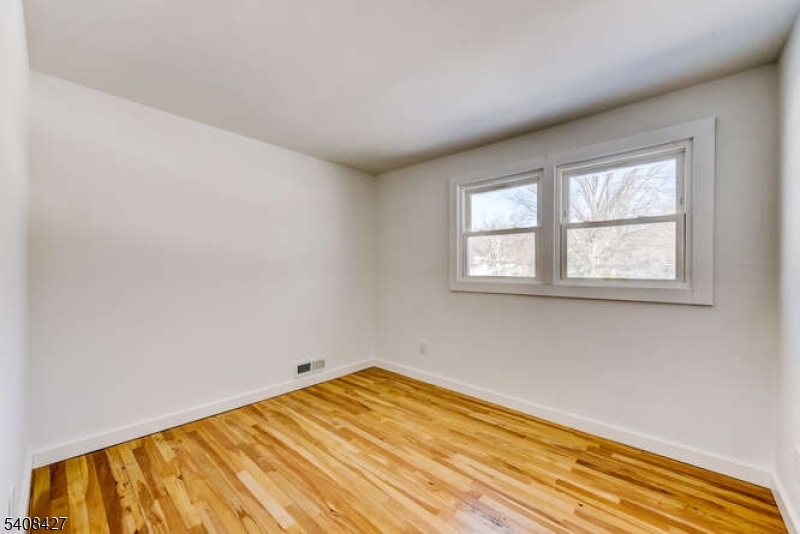 22 Glen Road Bridgewater, NJ 08805 - Photo 38 of 48 a view of empty room with wooden floor and fan