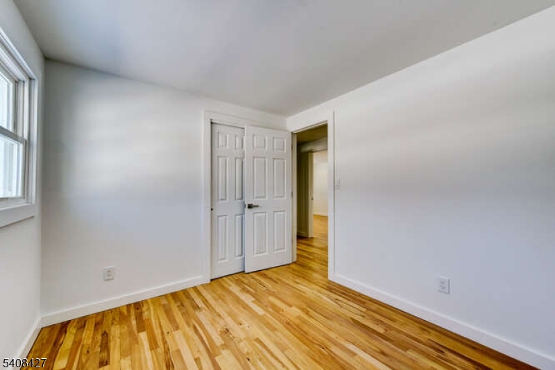 22 Glen Road Bridgewater, NJ 08805 - Photo 39 of 48 a view of an empty room and wooden floor
